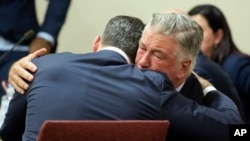 Actor Alec Baldwin, right, hugs his attorney Alex Spiro after a judge threw out the involuntary manslaughter case against him in the 2021 fatal shooting of cinematographer Halyna Hutchins on the set of the movie "Rust," July 12, 2024, in Santa Fe, N.M.