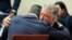Actor Alec Baldwin, right, hugs his attorney Alex Spiro after a judge threw out the involuntary manslaughter case against him in the 2021 fatal shooting of cinematographer Halyna Hutchins on the set of the movie "Rust," July 12, 2024, in Santa Fe, N.M.