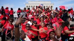 Members of Delta Sigma Theta Sorority Inc. pause for a photo in front of the Lincoln Memorial in Washington while they commemorate the 60th anniversary of the March on Washington for Jobs and Freedom, Aug. 26, 2023.