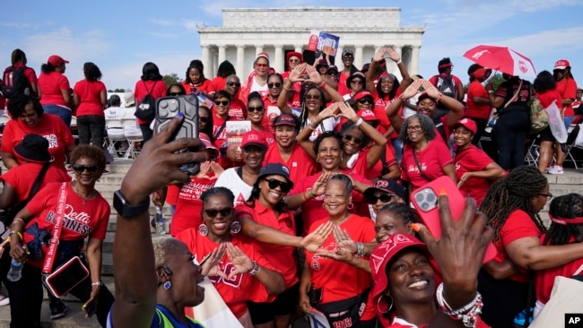 Members of Delta Sigma Theta Sorority Inc. pause for a photo in front of the Lincoln Memorial in Washington while they commemorate the 60th anniversary of the March on Washington for Jobs and Freedom, Aug. 26, 2023.