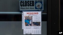 A missing person flyer for Joseph 'Lomsey' Lara is posted on the door of a business in a shopping mall in Lahaina, Hawaii, Aug. 21, 2023. 