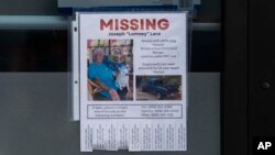 A missing person flyer for Joseph 'Lomsey' Lara is posted on the door of a business in a shopping mall in Lahaina, Hawaii, Aug. 21, 2023.