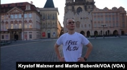 Wearing a #Free Alsu T-shirt, Pavel Butorin pauses in Prague’s Old Town on a morning run, July 10, 2024. The Current Time journalist says he never stops thinking about his wife, and how she is coping in prison in Russia.