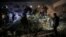 Firefighters and civilians gather at the rubble of a building following Israeli bombardment in Rafah, in the southern Gaza Strip, on Dec. 18, 2023, amid continuing battles between Israel and the Palestinian militant group Hamas.