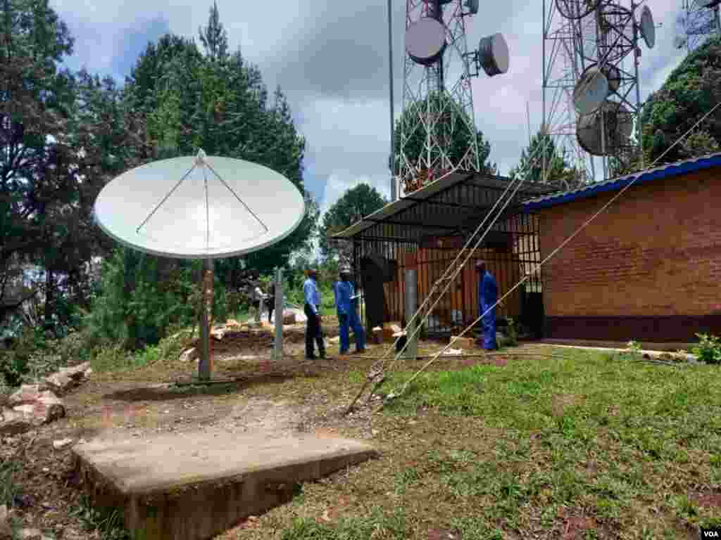 Technicians relax after the final adjustments were made to satellite equipment for VOA's new radio station serving Kirongi, Rwanda.