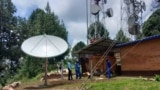 Technicians relax after the final adjustments were made to satellite equipment for VOA's new radio station serving Kirongi, Rwanda.