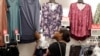 FILE - In this Aug. 28, 2018, photo, a shopper looks for clothing at a Kohl's store in Concord, North Carolina. "Fast-fashion" — inexpensive and trendy clothes — is causing environmental problems worldwide. 