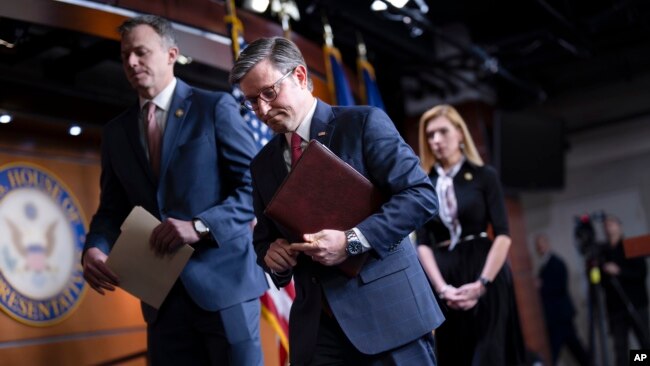 FILE - Speaker of the House Mike Johnson departs a news conference, with Republican colleagues Rep. Blake Moore, left, and Rep. Beth Van Duyne at the Capitol in Washington, Feb. 29, 2024.