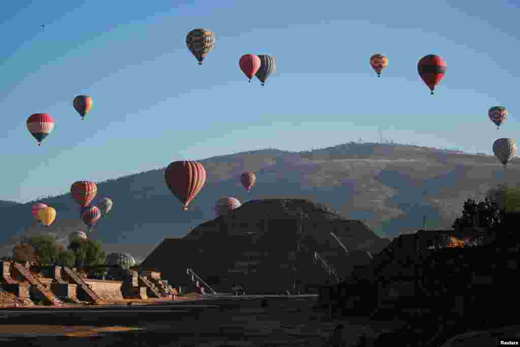 The Pyramid of the Moon is seen on the day of the spring equinox as hot air balloons float above the pre-hispanic city of Teotihuacan, on the outskirts of Mexico City, Mexico.