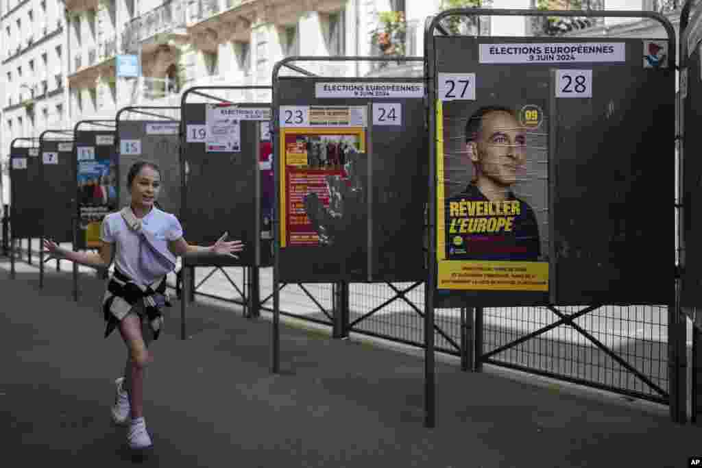 A child walks by campaign posters during the European Parliament elections, June 9, 2024 in Paris, France.