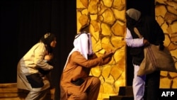 Actors perform a scene in a play during the 12th edition of the National Theatre Festival in Tripoli on December 20, 2023.