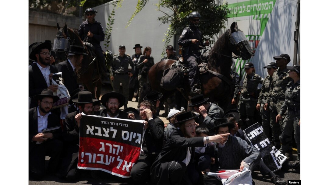 Ultra-Orthodox Jewish men gather after the Supreme Court ruled the defense ministry could no longer grant blanket exemptions to Jewish seminary students from military conscription, at Tel HaShomer recruitment base, in Ramat Gan, Israel, Aug. 5, 2024.
