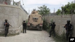 FILE - National Police patrol during an anti-gang operation in the Tabare neighborhood of Port-au-Prince, Haiti, July 25, 2023.