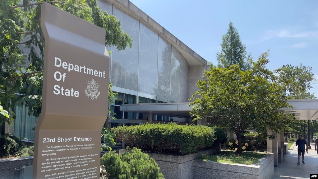 FILE — Signage is seen outside one of the entrances of the U.S. Department of State in Washington, Aug. 6, 2021.