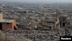 (FILE) A view shows houses destroyed in past Islamic State militant attacks, in the town of Sinjar, Iraq January 24, 2022.