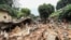 Residents look at the destruction caused by a landslide in the district of Mbankolo, northwest of Yaounde, Cameroon, Oct. 9, 2023. Heavy rains caused a section of a hillside covered in precariously built houses to collapse.
