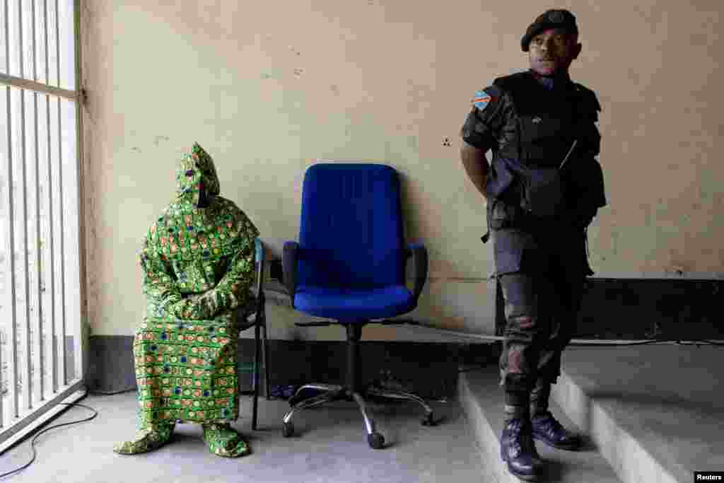 A masked witness is seen before testifying in front of the military court at the trial of six soldiers accused of the murder of 56 civilians during a demonstration against the presence of United Nations Organization Stabilization Mission in the Democratic Republic of the Congo (MONUSCO) and East Africa Community Regional Force (EACRF) at the military auditorium in Goma, North Kivu province, Sept. 15, 2023.&nbsp;