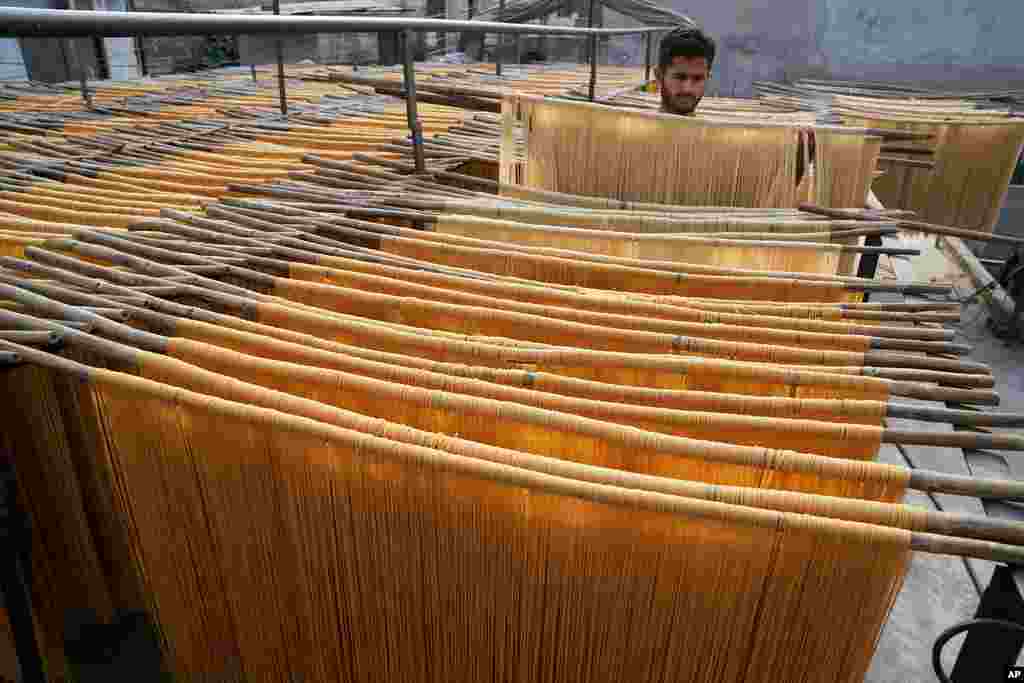 A vendor arranges traditional vermicelli noodles, a favorite during the Muslim's holy fasting month of Ramadan, at a factory, in Lahore, Pakistan.