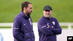 England manager Gareth Southgate, left, with assistant Steve Holland leads a training session ahead of Saturday's friendly soccer match against Brazil, at St. George's Park, Burton upon Trent, England, March 22, 2024.