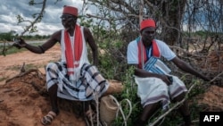 FILE: The local spiritual leaders from Kaya-Giriama ethnic group wait for the transport to visit the mass-grave site in the forest in Shakahola, outside the coastal town of Malindi, on April 24, 2023. 