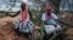 FILE: The local spiritual leaders from Kaya-Giriama ethnic group wait for the transport to visit the mass-grave site in the forest in Shakahola, outside the coastal town of Malindi, on April 24, 2023. 