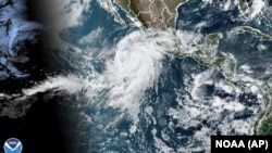 This satellite image taken at 10:50 a.m. EDT on Aug. 17, 2023, and provided by the National Oceanic and Atmospheric Administration shows Hurricane Hilary off the Pacific coast of Mexico. (NOAA via AP)