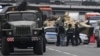 An APC and police officers stand on the highway on the outskirts of Moscow, Russia, June 24, 2023.