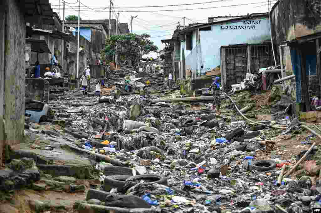 A street is littered with plastic waste in the popular commune of Attecoube, Abidjan.