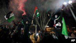 Demonstrators let off colored smoke as they gather near the White House during the March on Washington for Gaza on Jan. 13, 2024, in Washington.