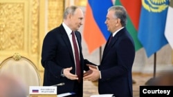 FILE — Uzbek President Shavkat Mirziyoyev talks with Russian leader Vladimir Putin during the Eurasian Economic Union summit, Moscow, May, 8, 2024. (President.uz photo)