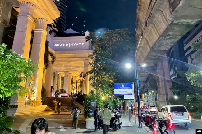 Orang-orang berjalan di luar hotel tempat sejumlah orang ditemukan tewas di Bangkok, Thailand, Selasa, 16 Juli 2024. (AP Photo/Napat Kongsawad)