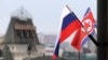 FILE - Flags of Russia and North Korea are seen in front of the central railway station in Vladivostok, Russia, April 24, 2019, ahead of a summit in the city between Russian President Vladimir Putin and North Korean leader Kim Jong Un.