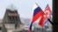 FILE - Flags of Russia and North Korea are seen in front of the central railway station in Vladivostok, Russia, April 24, 2019, ahead of a summit in the city between Russian President Vladimir Putin and North Korean leader Kim Jong Un.