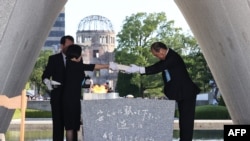 Hiroshima Mayor Kazumi Matsui and representatives of bereaved families enshrine a list of the atomic bomb victims at the cenotaph during a ceremony at the Peace Memorial Park in Hiroshima, Aug. 6, 2023.