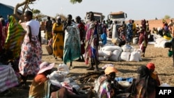 FILE - Internally displaced women wait for food rations to be distributed by the World Food Program in Bentiu, South Sudan, Feb. 6, 2023. Attacks on humanitarian aid workers have complicated the already dire food crisis in the country.