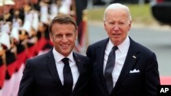 US President Joe Biden, right, and French President Emmanuel Macron arrive at the international ceremony at Omaha Beach, June 6, 2024, in Normandy, France. 