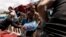 Volunteers load supplies onto a boat for West Maui at the Kihei boat landing, after a wildfire destroyed much of the historical town of Lahaina, on the island of Maui, Hawaii, Aug. 13, 2023. 