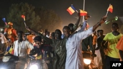Supporters of Chad's junta chief Mahamat Idriss Deby Itno celebrate their candidate's victory in a street in N'Djamena on May 9, 2024.