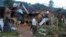FILE - A man looks at homes destroyed after air and artillery strikes in Mung Lai Hkyet displacement camp, in Laiza, Myanmar, Oct. 10, 2023.