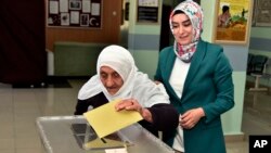112-year-old old Gullu Dogan votes at a polling station in Gumushane, Turkey, May 14, 2023.
