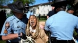 Georgia State Patrol officers detain a demonstrator on the campus of Emory University during a pro-Palestinian demonstration, April 25, 2024, in Atlanta.