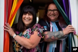 Avril Clark, left, and Lucy are pictured at their house in London, June 11, 2024. Lucy came out publicly as transgender in 2018 and brought the couple much attention.
