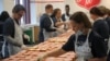 At a Salvation Army kitchen in Detroit, Michigan, local bank employees make sandwiches for people in need. 