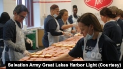 At a Salvation Army kitchen in Detroit, Michigan, local bank employees make sandwiches for people in need. 