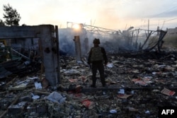 A police officer inspects damage to an industrial area in the Ukrainian capital, Kyiv, after a massive overnight missile attack on Ukraine Thursday, September 21, 2023.