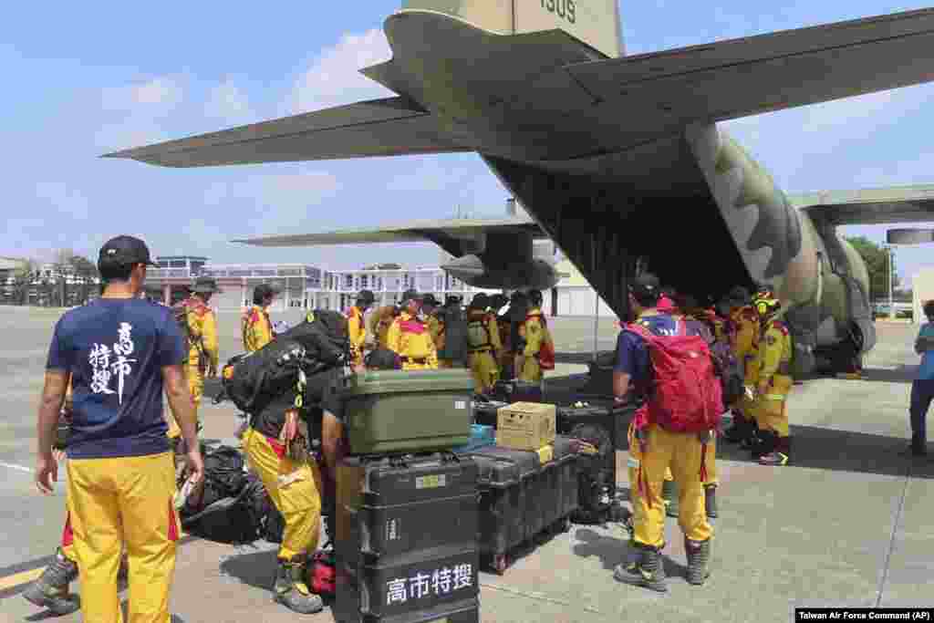 In this photo released by the Taiwan Air Force Command, members of a search and rescue team prepare to deploy on a Taiwan Air Force C-130 from southern Taiwan's Pingtung military air base en route for Hualien, April 3, 2024.