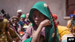 FILE: A refugee from the Democratic Republic of Congo (DRC) waits to receive lunch at the Nyakabande Transit Center in Kisoro, Uganda, June 7, 2022, following deadly fights between M23 rebels, one of more than 120 armed groups roaming eastern DRC, and DRC troops.