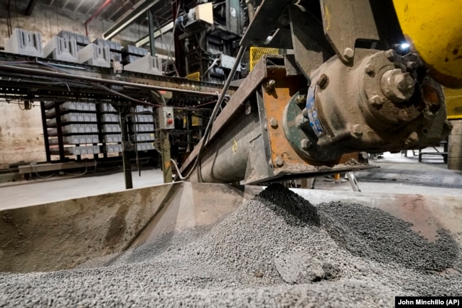 Excess material from freshly made concrete blocks, created with liquid carbon dioxide as an ingredient, is collected for reprocessing at the Glenwood Mason Supply Company, Tuesday, April 18, 2023, in the Brooklyn borough of New York. New York is forcing buildings to clean up, and several are experimenting with capturing carbon dioxide, cooling it into a liquid and mixing it into concrete where it turns into a mineral. (AP Photo/John Minchillo)