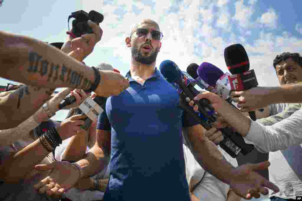 Andrew Tate speaks to media after being released from house arrest and put under judicial control measures, on the outskirts of Bucharest, Romania.&nbsp;Tate, the divisive internet influencer who is charged in Romania with rape, human trafficking, and forming a criminal gang to sexually exploit women, won an appeal Friday alongside his brother to be released from house arrest and will instead be put under judicial control measures, his spokesperson said.&nbsp;