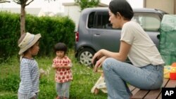 This photo provided by Japan Media Services shows a scene from The Ones Left Behind: The Plight of Single Mothers in Japan,' directed by Rionne McAvoy.